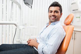 man smiling in dentist chair, Kent, WA dental implants